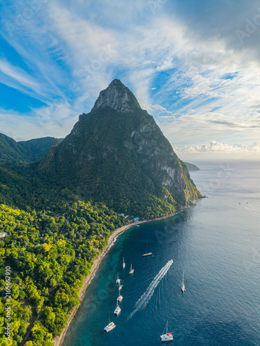 View of Piton National Park with green vegetation and boats near the coast in Saint Lucia