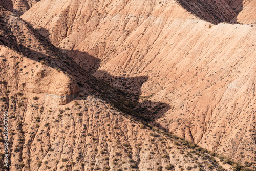 Eroded clay hills with ridges and dry vegetation in a semi-desert landscape of Andalusia