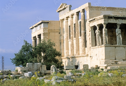 Erechtheum features Caryatids standing alongside ancient ruins on the Acropolis overlooking Athens
