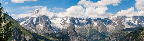 View of Mont Blanc massif from Arpy belvedere near La Thuile in Aosta Valley with clouds and clear sky