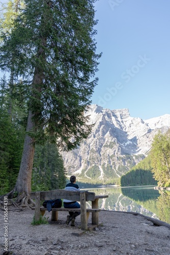 Konstfotografi Man enjoying tranquil view of Braies Lake Dolomites mountains