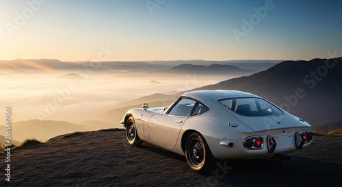 Vintage Sports Car on Mountain Hilltop at Sunset.