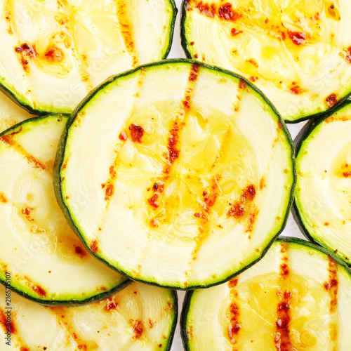 Grilled zucchini slices, top view, white backdrop closeup. AI