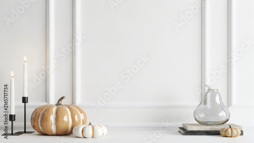 Halloween pumpkin and garlic bulbs on white kitchen counter for autumn harvest decor