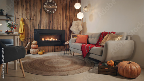 Cozy Halloween living room with fireplace, pumpkins, and festive autumn decor