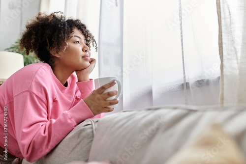 Quadro su tela Contemplating moments of joy and peace at home on a cozy afternoon