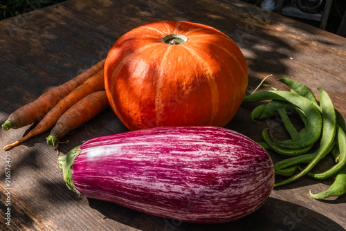 Organic vegetables on a wooden table outdoors in summer