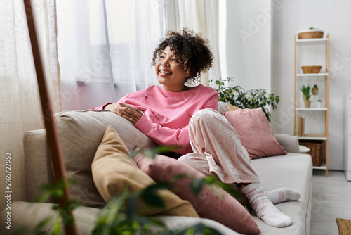 Quadro su tela Joyful moments of a young woman unwinding in her cozy home space