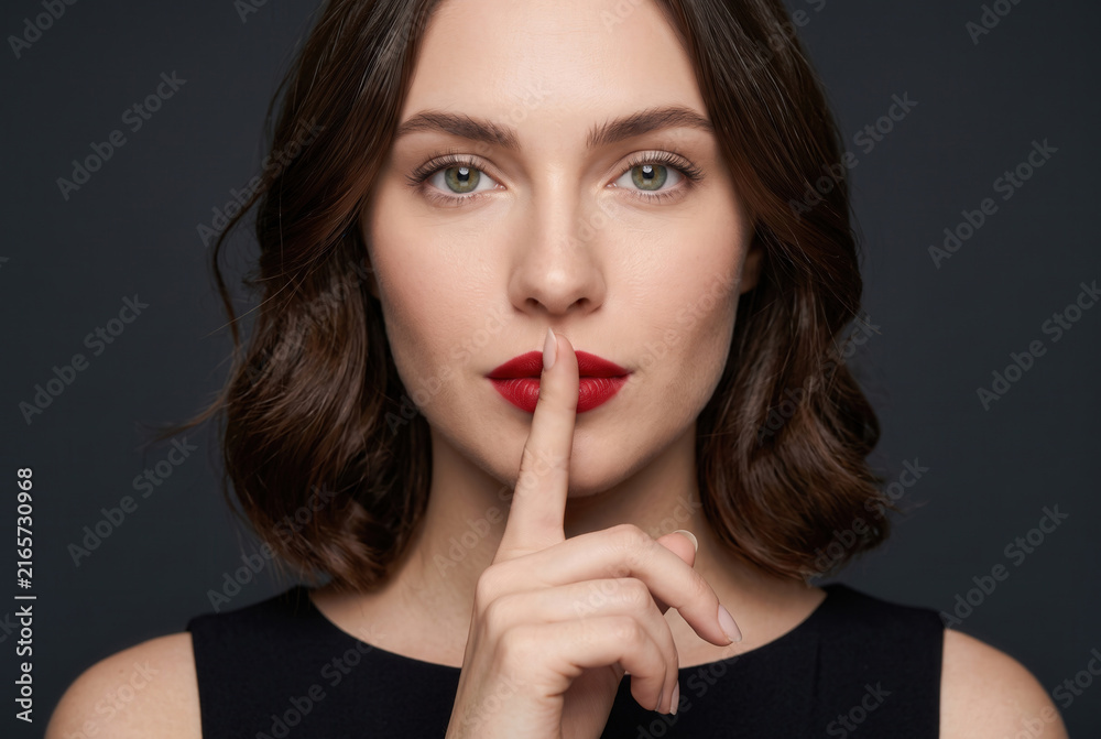 Naklejka premium Woman Making Silence Gesture With Finger on Lips