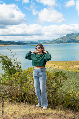 Smiling woman traveling by embalse del tomine enjoying nature