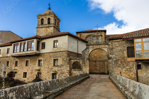 Puerta del Portazgo, 18th-century Baroque gate, and the medieval bridge of the same name, with its distinctive side benches. Palencia province, Castile and León, Spain.