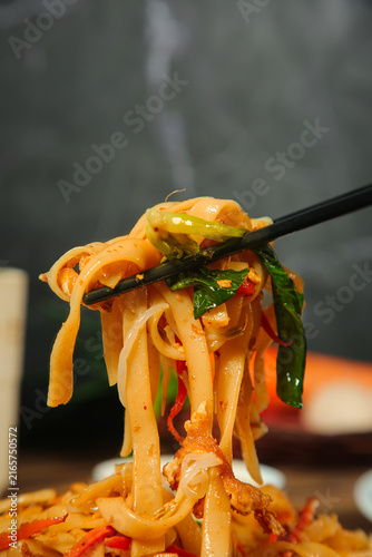 Bild auf Leinwand Stir-Fried Rice Noodles with Vegetables on Chopsticks - Asian Cuisine Food Photo