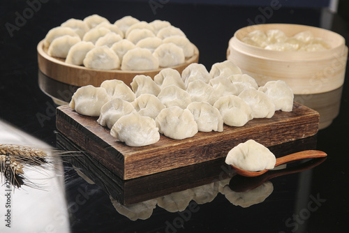 Bild auf Leinwand Handmade Seafood Dumplings with Traditional Bamboo Steamer on Wooden Board