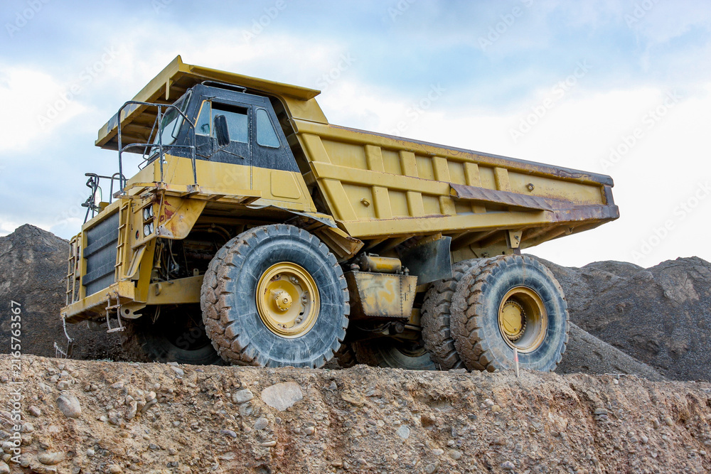 Fototapeta premium Heavy mining dump truck transporting earth material