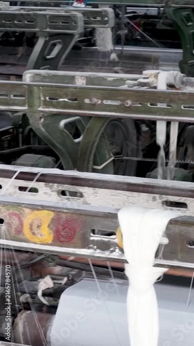 Close Shot Of Cotton Thread Bobbins On Weaving Loom vertical view
