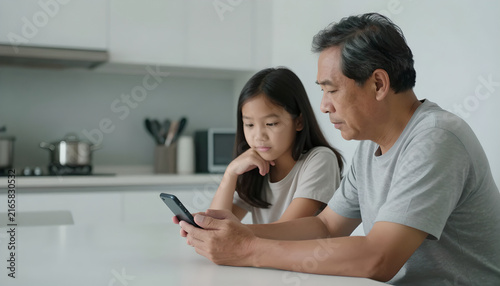 Older Adult Reviewing Mobile Payment with Family Member: Safety Check