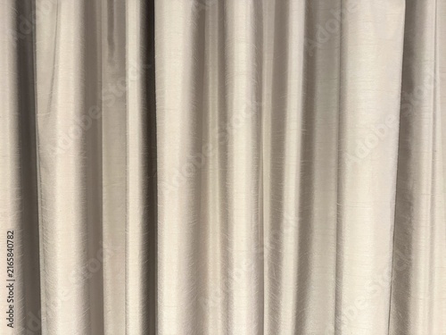 Photography Beige satin curtain with vertical folds, soft sheen, gentle ripples, and smooth