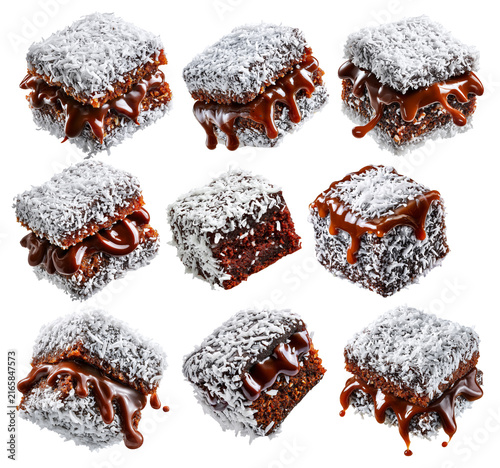 Chocolate-coated sponge lamington sponge cake covered in shredded coconut isolated on white background