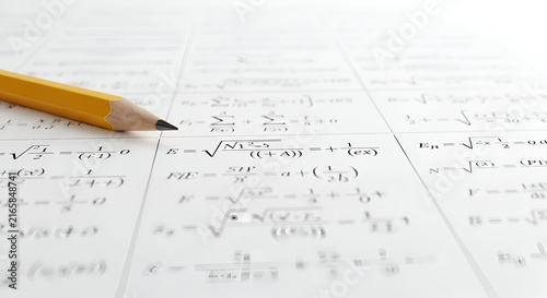 Yellow Graphite Pencil Resting on White Paper Filled with Complex Mathematical Equations and Advanced Calculus Formulas for Academic Study