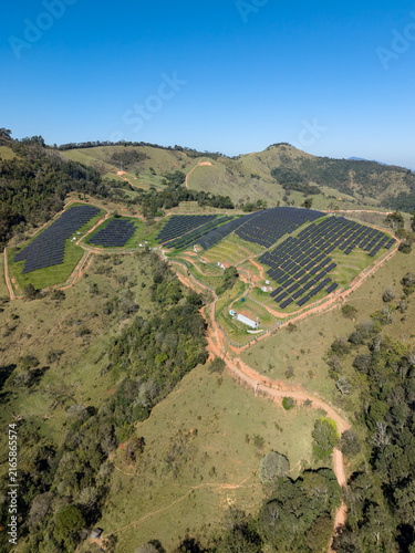 Aerial view of a solar energy farm on a mountain