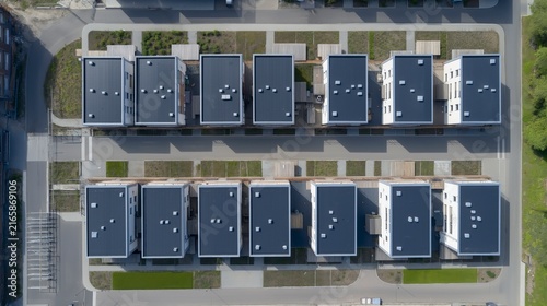 Modern Row Houses — New homes with flat EPDM roofs appear from an elevated angle on a sunny summer day, highlighting their clean forms and cohesive contemporary design.
