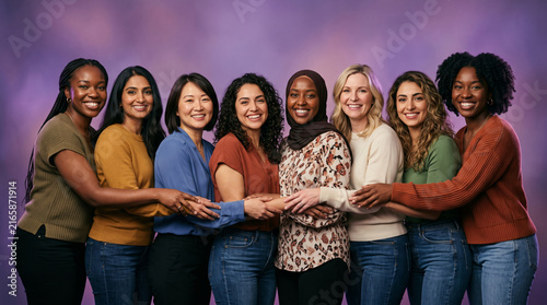 Diverse group of women of different ethnicities and ages standing together in unity