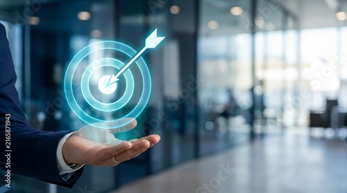 Business target and goal achievement concept. Businessman hand holding glowing neon bullseye
icon with arrow in office. Digital strategy and success