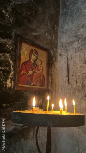 Burning Candles in Front of an Icon of the Virgin Mary
