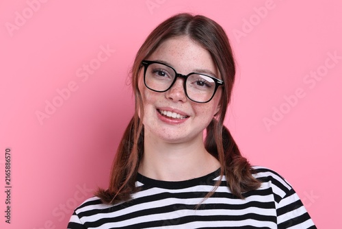 Konstfotografi Beautiful teenage girl with freckles on pink background