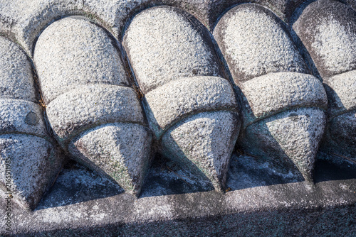 Detailed view of stone tortoise claw carving on traditional Buddhist temple monument base in South Korea.