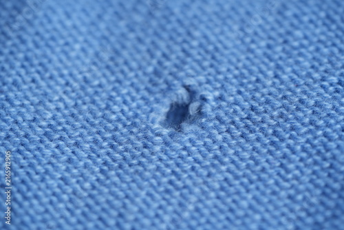 Canvas Print hole in a light blue woollen jumper, hole in a blue woollen jumper, texture of a
