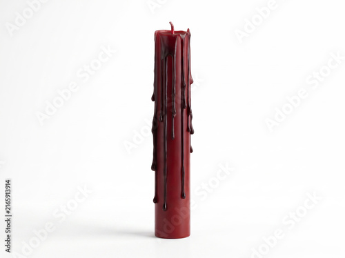 Blood-drip red taper candle with dramatic wax drips, isolated on a pure white background.
