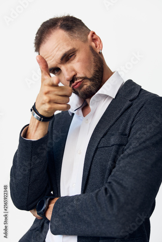 Cuadro en lienzo A confident business professional man poses with a playful finger gun gesture against an isolated light colored background, conveying focus, motivation, and assertive attitude