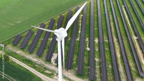 Ecological power station with solar panels and wind turbine in field