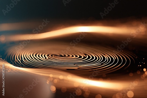 Fingerprint pattern with glowing gold lines on a dark background for biometric authentication, security, privacy, and identity verification.