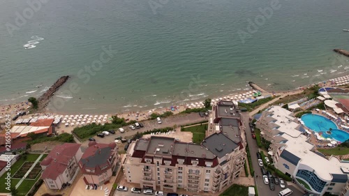 Panoramic aerial view of houses and hotels with pool, residential apartment, sea and beaches of Sveti Vlas in Bulgaria from above, top view from drone. Summer holiday in Europe. 
