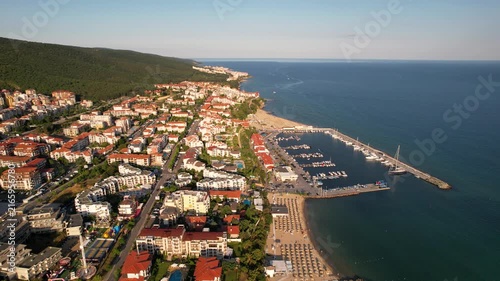 Marina port in Sveti Vlas. Panoramic aerial view of houses and hotels, sea and beaches of Sveti Vlas in Bulgaria from above, top view from drone. Summer holiday in Europe. 
