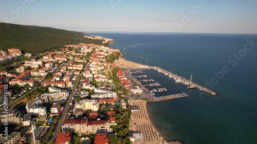 Marina port in Sveti Vlas. Panoramic aerial view of houses and hotels, sea and beaches of Sveti Vlas in Bulgaria from above, top view from drone. Summer holiday in Europe. 
