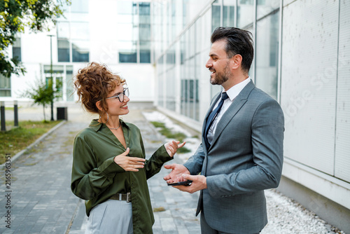 Business conversation between two professionals in a modern outdoor setting