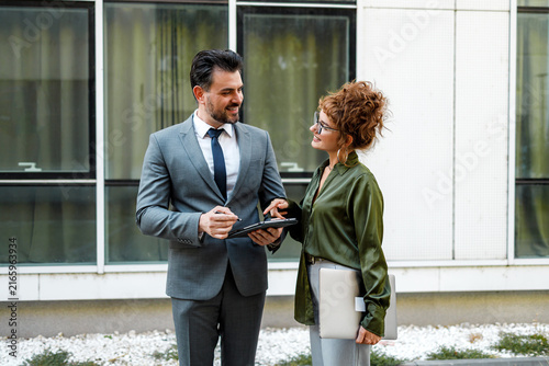 Photography Business meeting outside office building during daytime with two people