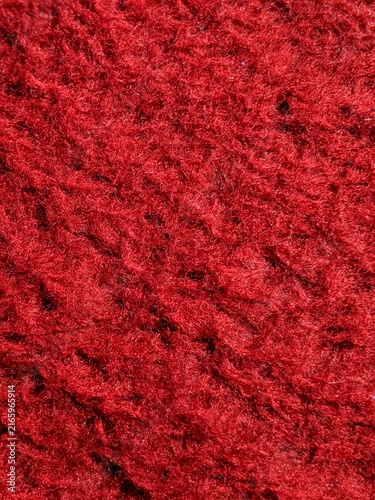 red carpet texture. Close-up of textured red fabric surface with fibrous details, highlighting irregular patterns and rich tactile depth.