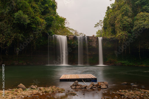 Tropical Waterfall and Floating Wooden Platform in Laos