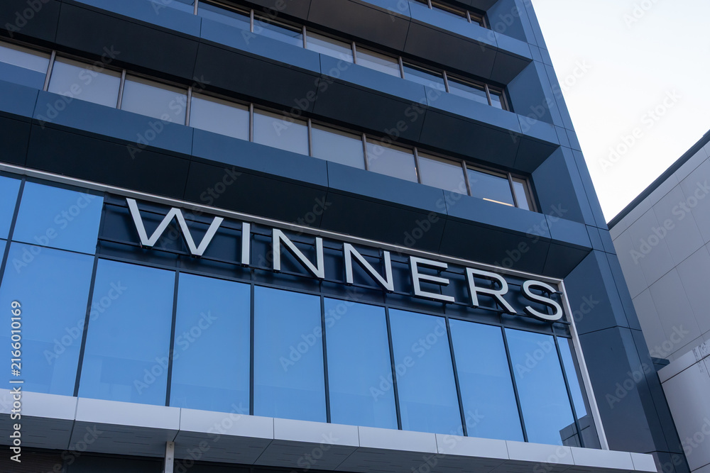 Obraz premium Toronto, ON, Canada - August 21, 2026: Closeup Winners logo sign on the building. Toronto, ON, Canada. Winners Merchants International LP is a chain of Canadian department stores owned by TJX.