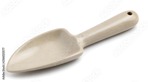 Angled close up of sleek beige gardening trowel on clean white surface for modern sustainable agriculture and minimalist houseplant care concepts