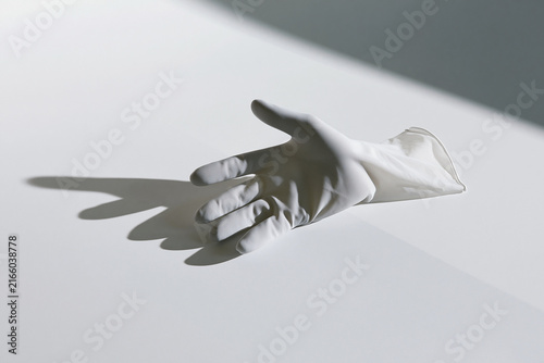 Empty glove casting an abstract shadow surreal concept