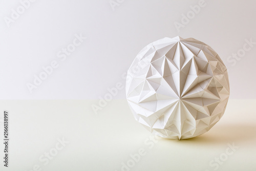 Geometric origami ball with folded facets surreal geometry concept