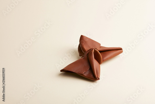 Butterfly folded from leather surreal origami craft concept