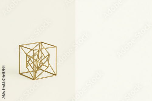 Brass wireframe tesseract hypercube surreal geometry concept