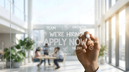 Businessman Writing “We’re Hiring, Apply Now” on a Glass Wall Representing Recruitment, Job Opportunities and Corporate Hiring