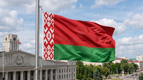 Konstfotografi National flag of Belarus waving on a flagpole against a blue sky and government building